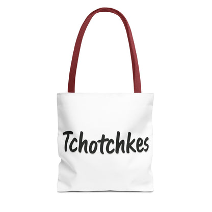White tote bag with red handles and 'Tchotchkes' text on a white background