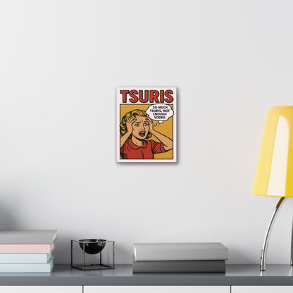 Framed poster with a comic-style design on a wall above a desk with books and a lamp.