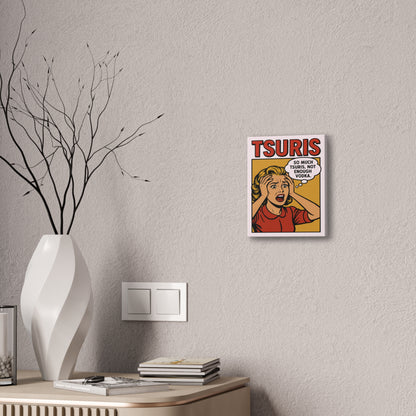Framed artwork with a humorous design on a wall above a desk with decorative items.