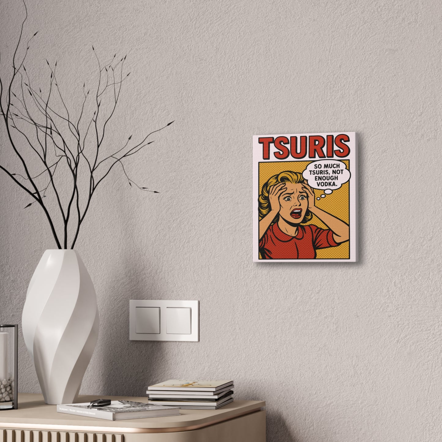 Framed artwork with a comic-style design of a woman and text on a wall above a desk.