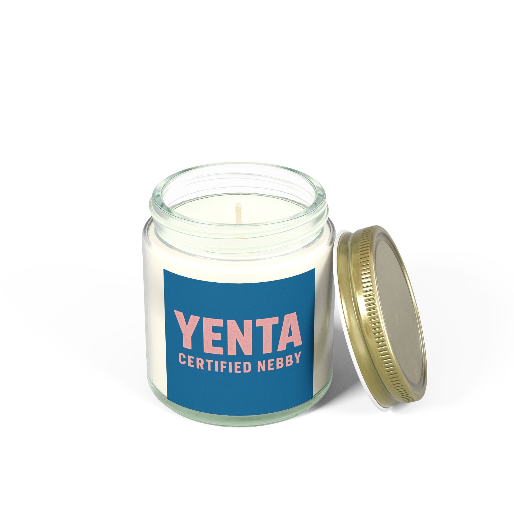 Candle in a glass jar with a blue label and gold lid on a white background